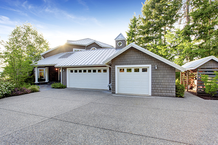 Modern House Exterior With Curb Appeal. View Of Garage And Spaci